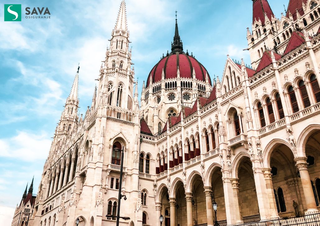 Mađarski parlament u Budimpešti sa logotipom osiguranja.